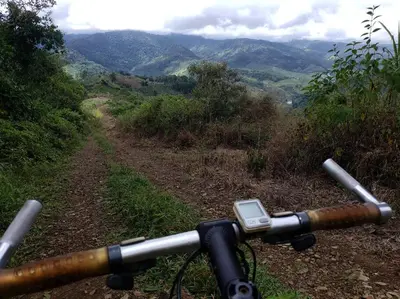 a view from the handle of a bike on a dirt road at Studio House in Eco-Farm: nature, relaxing, hiking in Turrialba