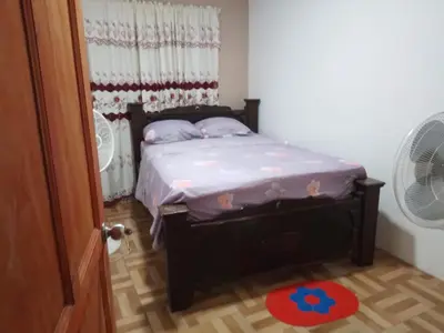 a small bed in a room with a fan at Apartamentos HJJ N 2 in Puerto Limón