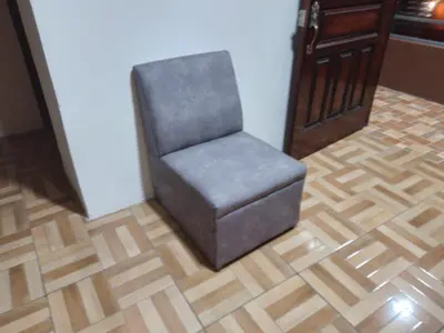 a chair sitting on a wooden floor in a room at Apartamentos HJJ N 2 in Puerto Limón