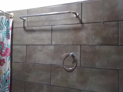 a wooden wall with a towel rack in a bathroom at Apartamentos HJJ N 2 in Puerto Limón