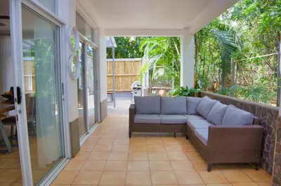 a porch with a couch on a patio at Mi Casa-stroll to the beach, ideal for 3-7 guest in Santa Cruz