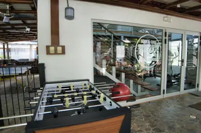 a room with a foosball table in front of a gym at Mi Casa-stroll to the beach, ideal for 3-7 guest in Santa Cruz