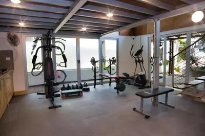 a gym with bikes and tread machines in a room at Mi Casa-stroll to the beach, ideal for 3-7 guest in Santa Cruz