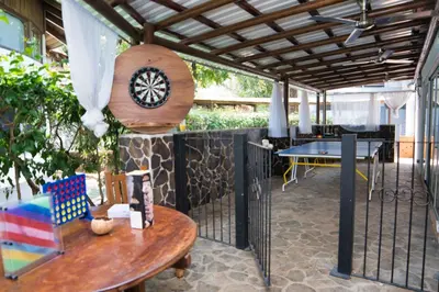 a patio with a table and a clock on a wall at Mi Casa-stroll to the beach, ideal for 3-7 guest in Santa Cruz