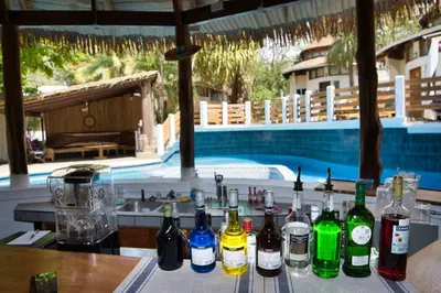 a bunch of bottles sitting on a table next to a pool at Mi Casa-stroll to the beach, ideal for 3-7 guest in Santa Cruz