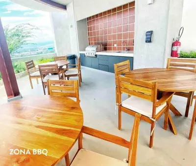 a room with wooden tables and chairs and a kitchen at Pura Vida Hub - Iconnia - Cash Only in San José