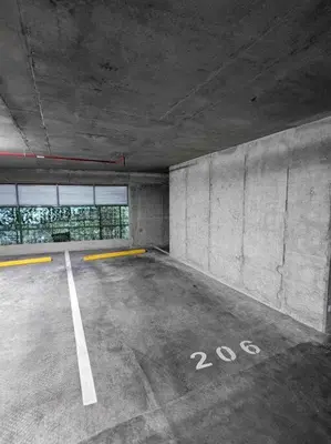 an empty parking lot in a parking garage at Pura Vida Hub - Iconnia - Cash Only in San José