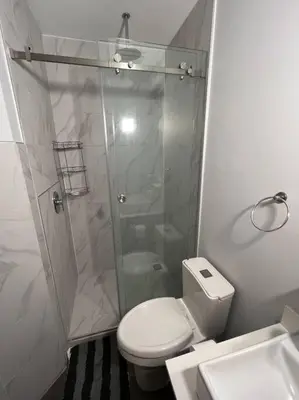 a bathroom with a shower and a toilet and a sink at Pura Vida Hub - Iconnia - Cash Only in San José
