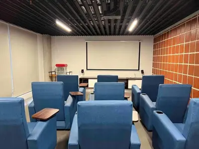 a classroom with blue chairs and a white board at Pura Vida Hub - Iconnia - Cash Only in San José