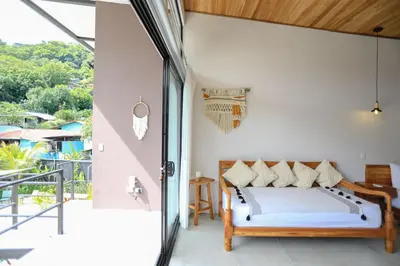 a bedroom with a bed and a balcony at Magic Place in Santa Teresa Beach