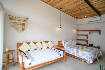 a bedroom with two beds and a staircase at Magic Place in Santa Teresa Beach