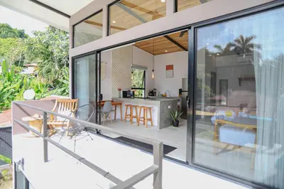 an open living room and kitchen of a house with sliding glass doors at Magic Place in Santa Teresa Beach