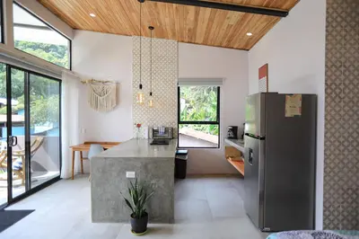a kitchen with a stainless steel refrigerator in a room at Magic Place in Santa Teresa Beach