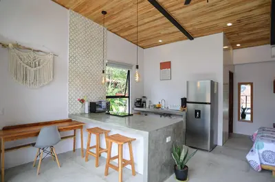 a kitchen with a counter and a refrigerator at Magic Place in Santa Teresa Beach
