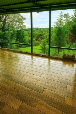 a room with a large window and a tile floor at La Cabaña in Heredia