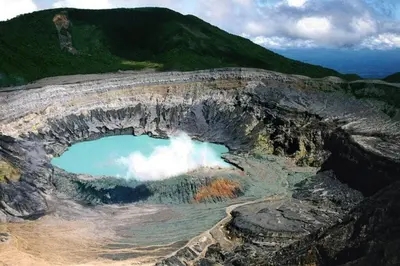 an aerial view of a mountain with a pool of water at La Cabaña in Heredia