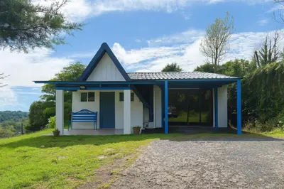 a small house with a blue roof at La Cabaña in Heredia