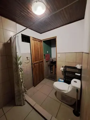a bathroom with a toilet and a shower at Casa el Colibrí in Naranjo