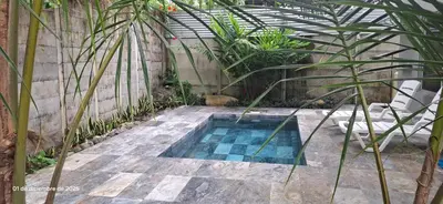 a swimming pool in a garden with plants at Uvita Stone House in Uvita