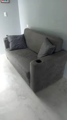 a brown couch in a living room at Uvita Stone House in Uvita
