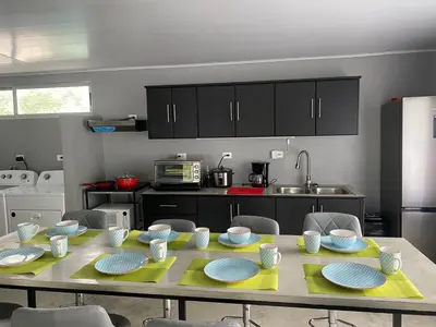 a kitchen with a table with plates on it at Uvita Stone House in Uvita