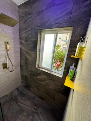 a bathroom with a window and a shower at Luxury Condo at Los Sueños Resort & Marina in La Mona