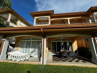 a house with a hammock on the porch at Luxury Condo at Los Sueños Resort & Marina in La Mona