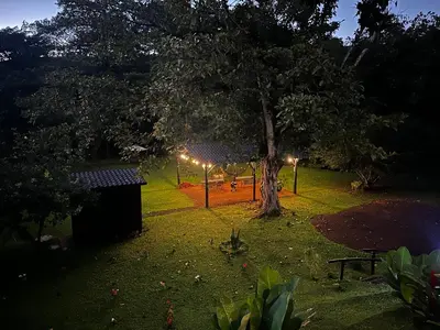 a park at night with a tree and lights at Ceibo Lodge, great birdwatching in Bijagual