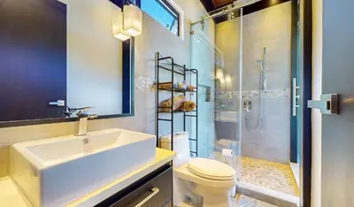 a bathroom with a sink and a shower and a toilet at Odyssey Villa, 3 bedrooms with Pool! in San Luis