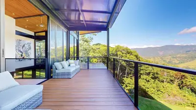 a balcony of a house with a view of the mountains at Odyssey Villa, 3 bedrooms with Pool! in San Luis
