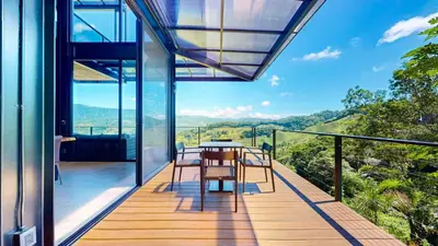 a glass house with a table and chairs on a balcony at Odyssey Villa, 3 bedrooms with Pool! in San Luis