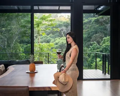 a woman in a dress holding a glass of wine at Odyssey Villa, 3 bedrooms with Pool! in San Luis