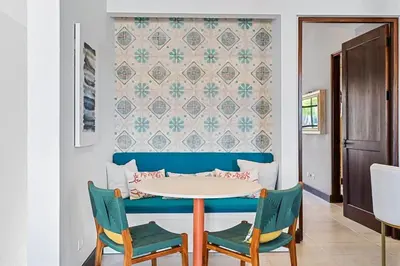a dining room with a table and two chairs at Trendy Condo with Stunning Ocean Views and Exclusive Beach Club Access in Las Catalinas in Playa Danta