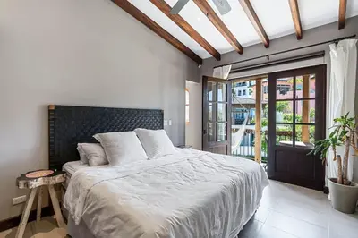 a bedroom with a large bed and a large window at Trendy Condo with Stunning Ocean Views and Exclusive Beach Club Access in Las Catalinas in Playa Danta