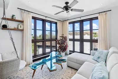 a living room with a couch and a table at Trendy Condo with Stunning Ocean Views and Exclusive Beach Club Access in Las Catalinas in Playa Danta