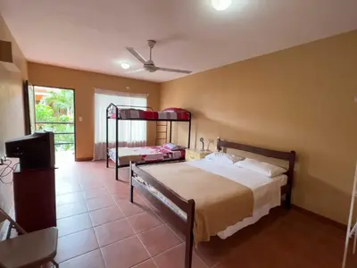 a bedroom with two beds and a flat screen tv at Belen Suites in San Antonio