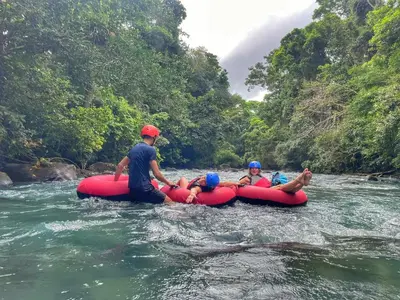 a group of people on a raft in a river at Cabinas Río Frío in San Rafael