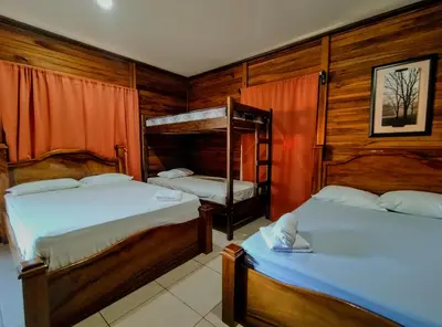 two bunk beds in a room with wooden walls at Cabinas Río Frío in San Rafael