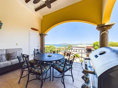 a patio with a table and chairs on a balcony at Sunrise 4-Beautiful 3Br Penthouse Condo in Tamarindo