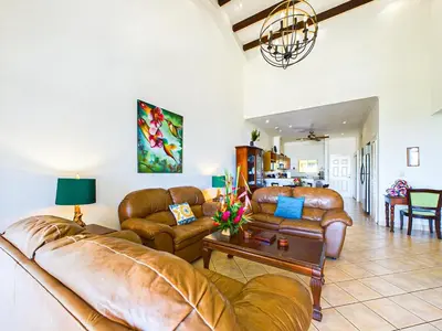 a living room with leather couches and a table at Sunrise 4-Beautiful 3Br Penthouse Condo in Tamarindo