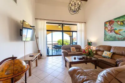 a living room with a couch and a table at Sunrise 4-Beautiful 3Br Penthouse Condo in Tamarindo