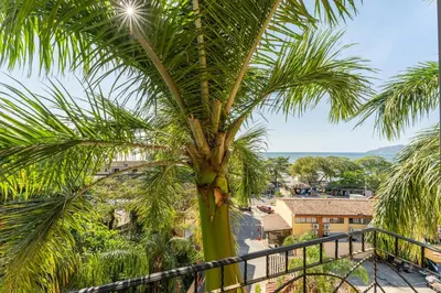 a palm tree sitting on top of a balcony at Sunrise 4-Beautiful 3Br Penthouse Condo in Tamarindo
