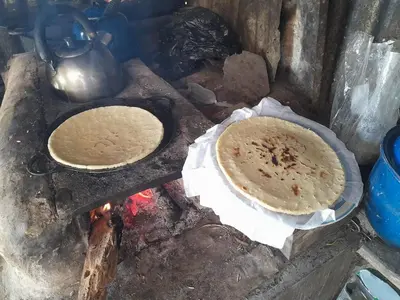 two pizzas are cooking on top of a stove at Finca Del Cielo in El Castillo de la Fortuna