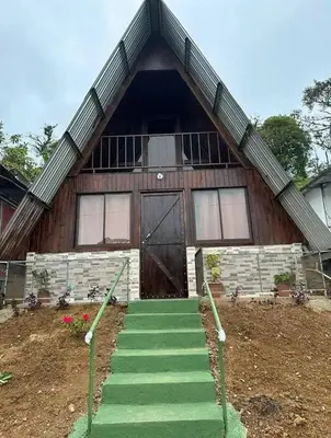 a house with a staircase leading to a door at Bungalow Tenorio Mountain Lodge in Rio Celeste