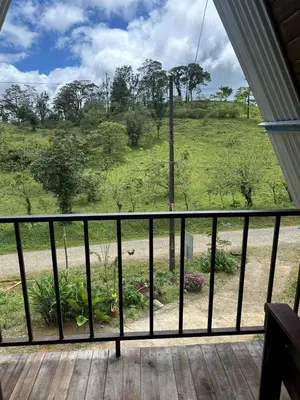 a balcony with a view of a field at Bungalow Tenorio Mountain Lodge in Rio Celeste