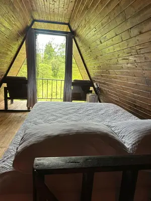 a large bed in a room with a window at Bungalow Tenorio Mountain Lodge in Rio Celeste
