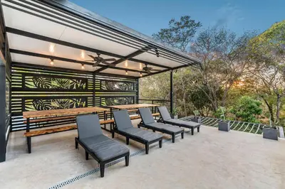 a group of chairs and a table on a patio at Brand-New 6BD Giant with Private Pool by SPCR in Potrero