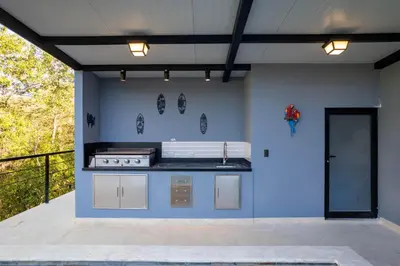 a kitchen with a stove and a blue wall at Brand-New 6BD Giant with Private Pool by SPCR in Potrero