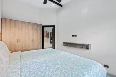 a bedroom with a large bed and a ceiling fan at Brand-New 6BD Giant with Private Pool by SPCR in Potrero