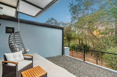 a porch with a swinging chair and a balcony at Brand-New 6BD Giant with Private Pool by SPCR in Potrero